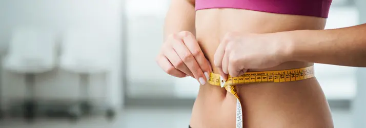 Woman Measuring Her Stomach After Weight Loss
